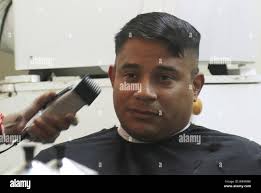 Maj. David Leiva, 184th Sustainment Command, gets a haircut