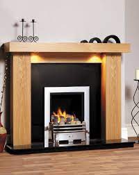 Variegated tones and textures match the room's neutral color palette and add dimension to the room. Manhattan Fireplace Surround Wood Fire Surrounds