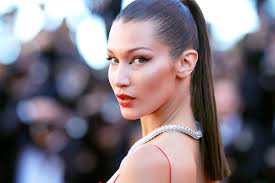 Woman looking at dirty clothes. Bella Hadid Goes Back To Original Dirty Blonde Hair Color Bella Hadid Hair