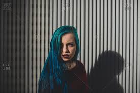 A shrinking violet with blue hair. Punk Girl With Blue Hair Looking Away Against Striped Background Stock Images Page Everypixel