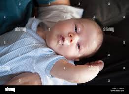 One Month Age Newborn Baby Face Open Eyes Looking At Camera On Man Father Arms Stock Photo Alamy