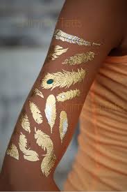 The original gold & silver temporary tattoos worn by beyonce, vanessa hudgens, alessandra ambrosio & more. Gold Metallic Gold Feather Tattoo Metallic Tattoo Feather Etsy