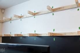 A floating shelf may have two or more channels open from the back towards, but without reaching, the front, into which slide fasteners attached to the wall. How To Make Very Long Floating Shelves Nelidesign