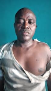 Armed police officers are moving in to arrest the living or dead body of  Edriss Bility