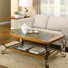 It has a smooth, brown laminate top and black metal, open frame legs. Slate Coffee Table Coffee Table Furniture Slate Coffee Table