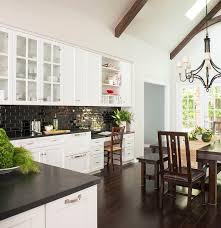 Tired of dragging the dining room chair into the kitchen to reach everything in your wall cabinet? Black And White Kitchen With Drop Down Desk With Overhead Pigeon Hole Cubby Transitional Kitchen