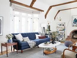 Attentive african american freelancer reading notebook while sitting on sofa near table with laptop. How To Design A Formal Living Room That Doesn T Feel Dated