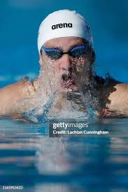Swimmers dive into the pool during day 3 of the Phillips 66 National...  News Photo