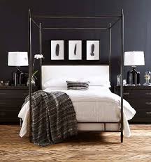 The bed has a dark wooden headboard which acts as a separation from the bright white bedding coverings and black painted walls. 75 Beautiful Black Master Bedroom Ideas Designs July 2021 Houzz Au