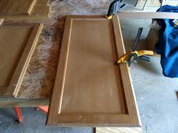 Add a small piece of moulding all the way around the front of the cabinet frame to hide the rough edges where you cut out the door. How To Add Glass To Kitchen Cabinet Doors