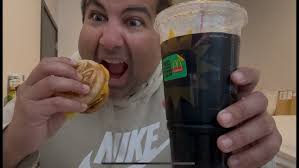 Adam Warhol eating a hamburger