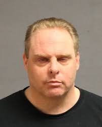 T cop held after armed standoff at N.H. hotel