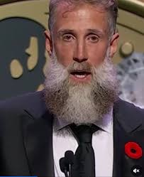 Bruins alumni game announcer with many hats