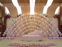 Balloon wall engagement decoration at home. 9 Incredibly Awesome Ways To Add Balloons To An Indian Wedding Decor Wedding Stage Decorations Stage Decorations Simple Stage Decorations