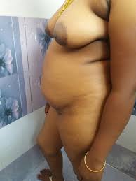 Nude Desi aunty wearing just her mangalsutra and showing her big boobs is  taking bath