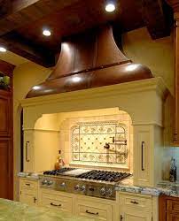 Most range hoods have straight, square bases, but this slightly curved range hood mimics the stone curve behind the pot filler for a unique twist on a wooden range hood. Top 7 Kitchen Range Hood Designs You Should Consider
