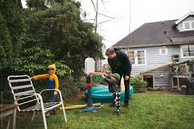 Some kids love playing badminton as it is a fun game to play with friends. Dad And Kids Playing In Backyard By Rob And Julia Campbell