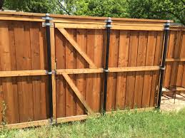 Stabilize Wood Fences With Metal Poles Wood Fence Building A Fence Cheap Fence Posts