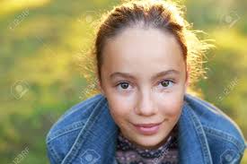 Beautiful Teenager Girl With Happy Facial Expression Looking At Camera With Joy.  Close Up. Front View. Happy Kid Outdoors Stock Photo, Picture and Royalty  Free Image. Image 165682822.