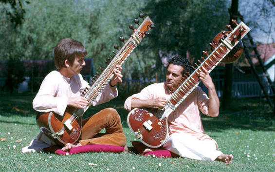 Sankar (R) teaching Harrison (L) to play the sitar