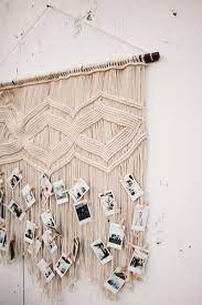This is a wall hanging project you can use as window valance or headboard. Boho Chic Wedding Decor Ideas Macrame Wall Hanging Used As Wedding Polaroid Photo Display Wedding Photo Walls Wedding Photo Wall Display Wedding Guest Book