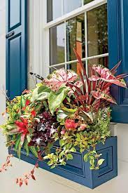 The flowers aren't in the ground. 9 No Fuss Floral Decorating Ideas For Your Front Porch Window Planter Boxes Window Planters Porch Flowers