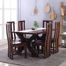 The table's surface is resistant to liquids, food stains, oil, heat, scratches and bumps, while its construction is stable, strong and durable to withstand years of daily use. Clovis Capra 6 Seater Dining Table Set Mahogany Curator S Cart
