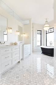 Thanks for visiting our white primary bathroom photo gallery where you can search a lot of white primary bathroom design ideas. Elegant White Bathroom With Black Accents Is Fitted With A Black Pedestal Bathtub Pla White Bathroom Designs White Master Bathroom Contemporary White Bathrooms