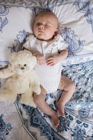 Wallpaper is from livette's wallpaper scandinavian collection and the simple crib from babyletto. Top View Of Baby Sleeping On Bed With Teddy Bear In Bedroom Person People Stock Photo 227247732