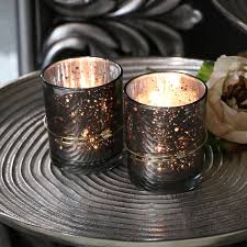Pair Of Grey Glass Tealight Candle Holders Glass, wood, silver and other luxurious materials create this series of stunning designs that will complement a variety of interiors.