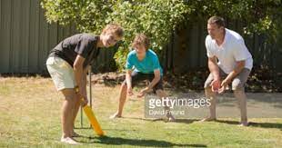 Family Playing Backyard Cricket In The Australian Summer Backyard Cricket Stock Photos