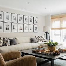 Long Cream Sofa With Chaise Lounge Under Black And White Photo Wall Cream Sofa Living Room Cream Sofa Design Cream Sofa