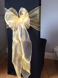 Black Chair Covers With Gold Organza Sash Available To Hire For Weddings And Events In Swansea Cardiff Neat Wedding Chair Decorations Prom Themes Prom Decor