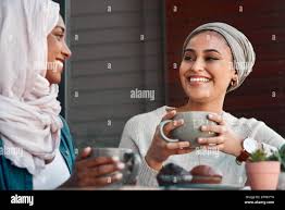 Spending time together is always such a bliss. two affectionate young  girlfriends having coffee with muffins at a coffee shop while dressed in  hijab Stock Photo - Alamy