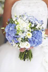 Embrace this unique fall wedding color palette by adding blue thistle and dark orange roses to your bouquets. Pale Blue Hydrangea White Ranunculus Blue Forget Me Nots White Freesia Wedding Hand Tie Blue Wedding Flowers Wedding Bouquets Hydrangea Bouquet Wedding
