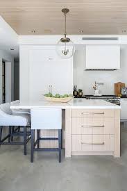 Kitchen with a gray glass front cabinet adorned with cremone bolts, fulham brass online cremone bolts hardware. Gold Stained Wood Island With Heather Gray Stools Transitional Kitchen