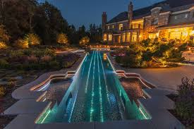 Pool Enclosure Lighting With Contemporary Pool And Backyard Pool Contemporary Pool Cool Pool Exterio Lap Pool Night Lighting Outdoor Lighting Pool Lighting Stone Chimney Stone Wall Swimming Pool Unique Pool Waterline Tile