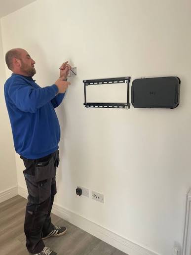 Crayford installer using spirit level to mount TV bracket