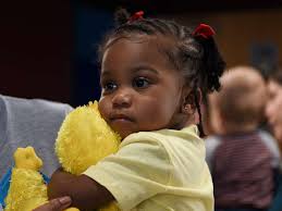 Bailey Lawson, 1, holds a Big Bird at the Sesame Street