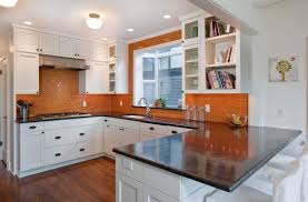 Accent colors include a deep brown range hood, black kitchen island, and deep grey marble countertops. 83 Exciting Kitchen Backsplash Trends To Inspire You Home Remodeling Contractors Sebring Design Build
