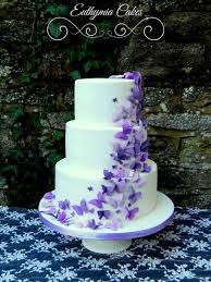 White Wedding Cake With Purple Butterflies By Euthymia Cakes Milton Keynes 460633868134020126 Purple Wedding Cakes Butterfly Wedding Cake Wedding Cake Maker