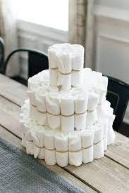 Cut your thinner ribbon to the width of your cake and set in place with tape. Pink Floral Diaper Cake The Only Diaper Cake Tutorial You Ll Need A Hosting Home