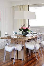 This dining table enhances the look of your dining room with its glam base and expansive surface. As Seen In Style At Home Magazine Arianna Belle Ghost Chair Dining Room Acrylic Dining Chairs Dining Room Chairs