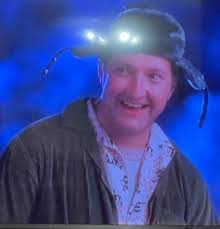 Can anyone determine what Eddie's shirt says in the scene where they arrive  & they are in yard...its got cows