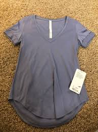 Brand New Lululemon Love Tee Size 4 Color Is Pepu Pretty Lighter Purple Color Has The Cuffed Sleeves Can Ship Asap Located In C Women Tees Women S Top