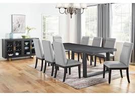 Table extends by pulling both ends and dropping in the leaf. Yves Grey Rectangular Dining Set W 8 White Chairs Ivan Smith Furniture