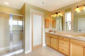 Frosted glass double doors open to a gorgeous bathroom filled with a crystal droplets flush mount placed above a rectangular freestanding tub and an iron freestanding towel holder placed below windows dressed in white roller shades. Oak Shaker 1 Light Frosted Glass Internal Door Green Tree Doors