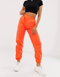 Black And Orange Cargo Pants Missguided Reflective Cargo Trousers In Orange Asos Orange Pants Outfit Neon Outfits Orange Outfit