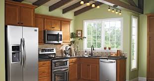 Maple Cabinets With Light Sage Green Paint On The Walls Black Granite Pretty Lighting And Stainless Ste Kitchen Cabinets Brown Kitchen Cabinets Wood Kitchen