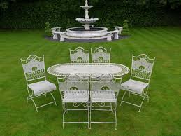 Someone took old garden tools and gave them new life. White Jayden Ornate Metal Garden Patio Table Set